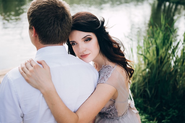 Elegant bride and groom posing together outdoors on a wedding day