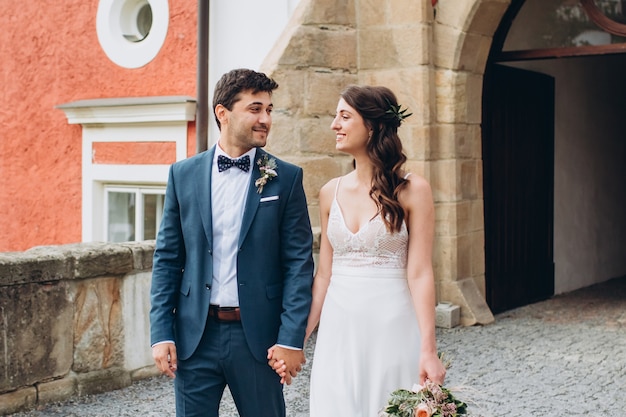 Elegant bride and groom posing together outdoors