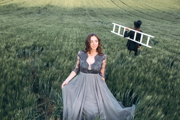 Elegant bride and groom walking and posing on green field