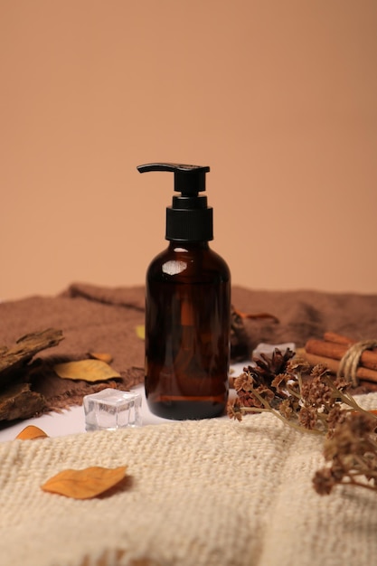 elegant brown pump bottle surrounded by autumn leaves and natural elements