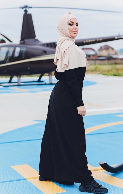 Elegant business muslim arab woman near the helicopter Business success and luxury concept