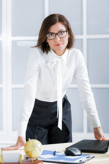 Elegant business woman in glasses  in the office.