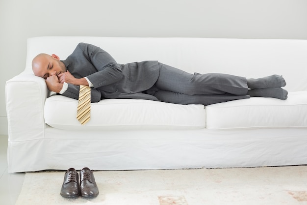 Elegant businessman sleeping on sofa