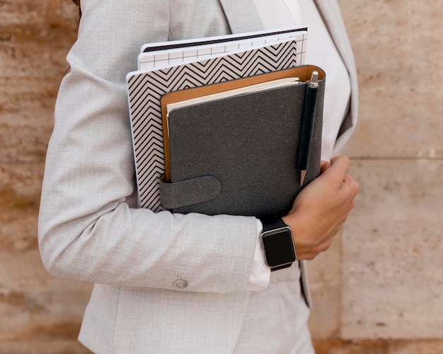 Photo elegant businesswoman holding agenda and notebook