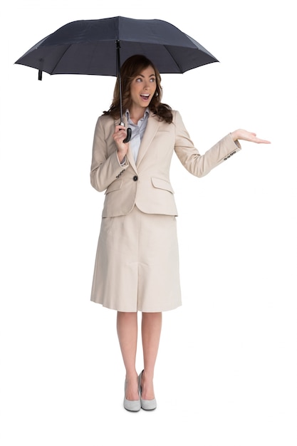 Elegant businesswoman holding black umbrella