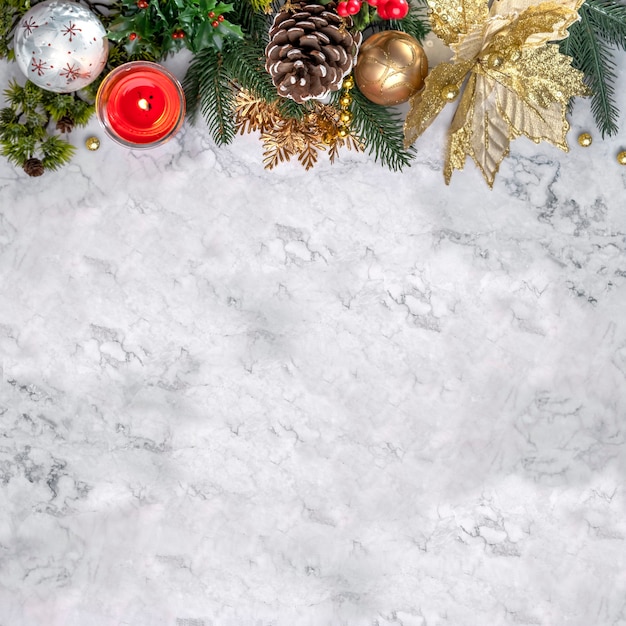 Elegant Christmas decor on white marble. Flatlay with copy space. New Year's spruce branches, cones, balls, gold decorations. Luxury background for design greeting card, poster, party invitation