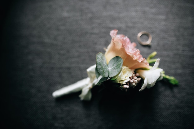 Elegant and classy groom boutonniere with amazing pink and white colored rose and wedding ringsx9