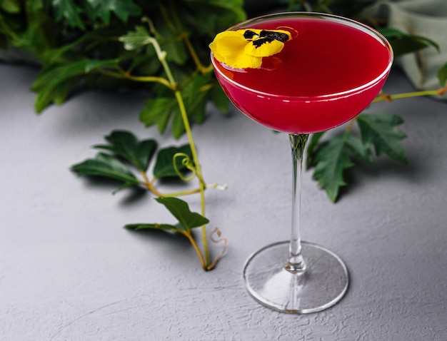 elegant cocktail with edible flower garnish
