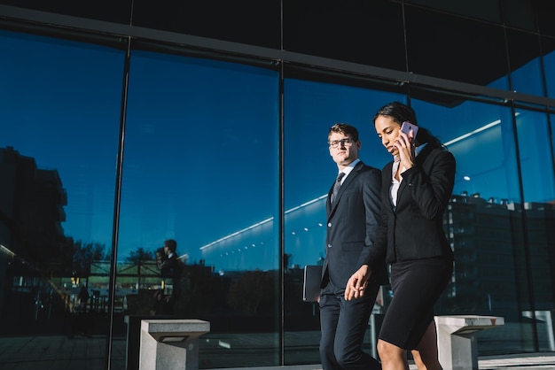 Elegant coworkers on city street