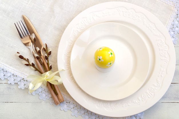 Elegant empty white plate, cutlery on linen napkin