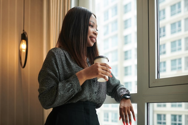 Elegant Entrepreneur Standing at Window