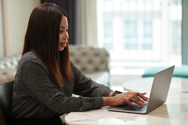 Elegant Entrepreneur Working on Laptop