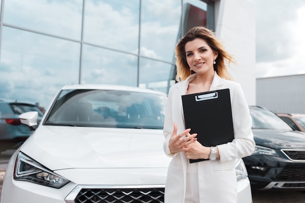 Elegant female in car dealership