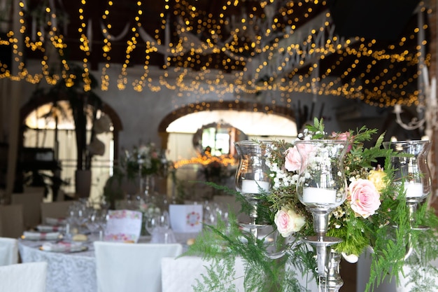 Elegant floral centerpiece illuminating wedding reception venue