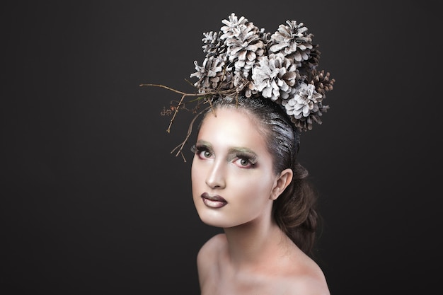 Elegant Girl in the New Year Wreath of Pine Cones