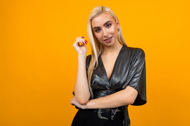 elegant girl posing on a yellow background with copy space