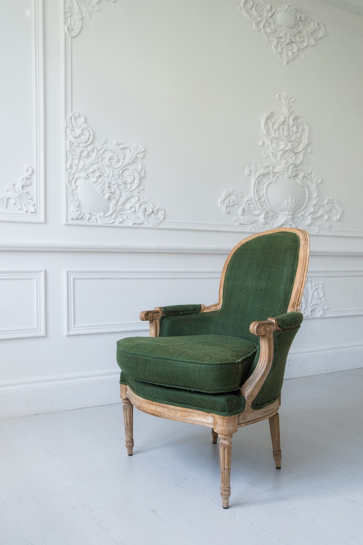 Elegant green armchair in luxury clean bright white interior