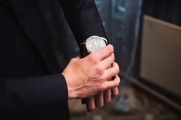 Elegant groom dressing in a wedding suit