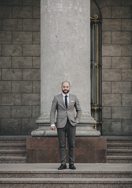 Elegant handsome man in full suit and shoes in old city