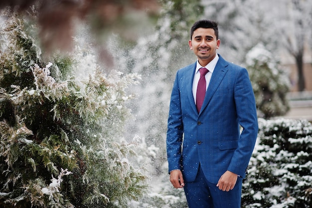 Elegant indian fashionable man model on suit posed at winter day