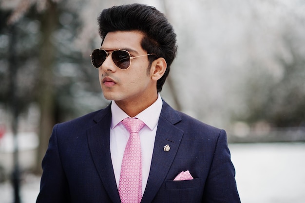 Elegant indian macho man model on suit and pink tie sunglasses posed on winter day