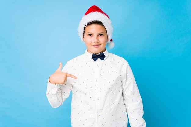 Elegant kid wearing a santa hat on a christmas day