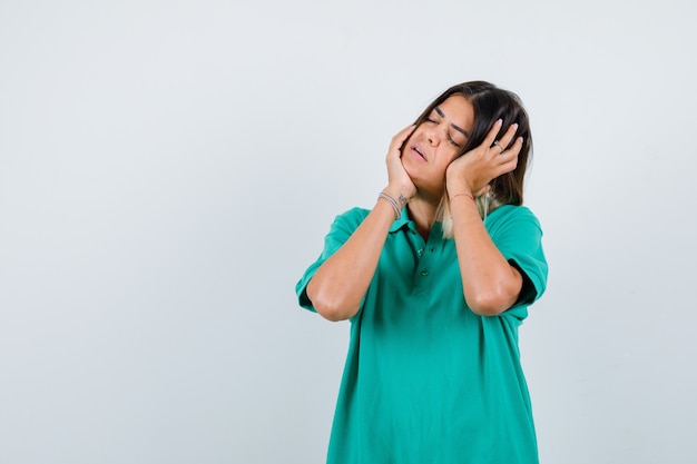 Elegant lady stretching neck in polo t-shirt and looking tired , front view.