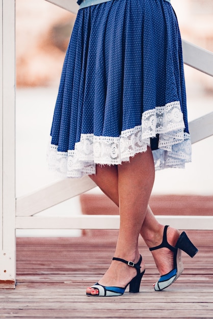 Elegant lady with beautiful legs in high heel shoes. Provence stile skirt and shoes.