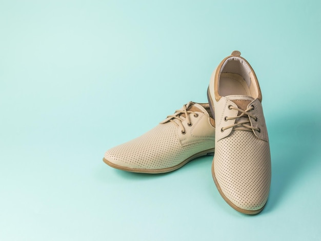 Elegant light summer men's shoes on a light blue background