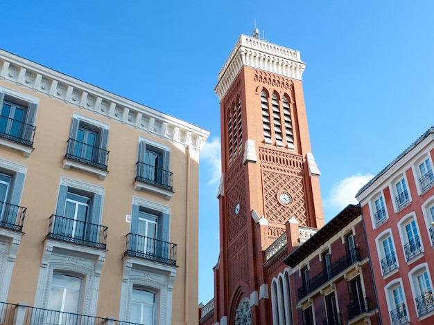 Elegant lines of classical buildings touristic part downtown Madrid Spain Tower Church Saint Cross