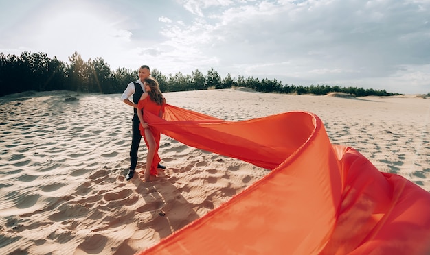 Elegant lovely couple posing on the beach