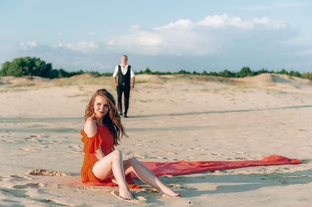 Elegant lovely couple posing on the beach