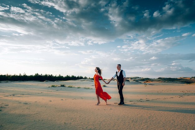 Elegant lovely couple posing on the beach