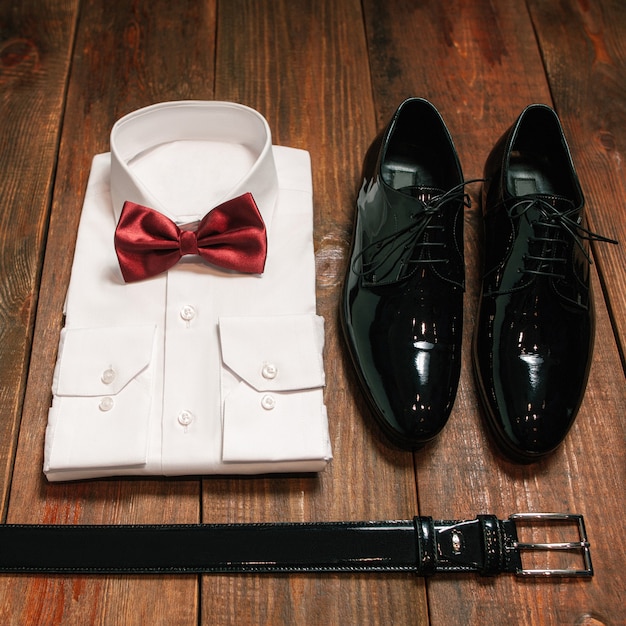 Photo elegant male cloth set. white shirt bow tie black shoes belt.