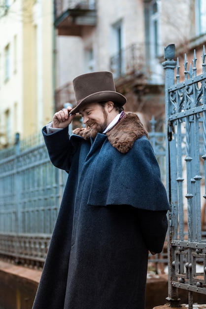 Elegant man. The gentleman in a coat and a top hat