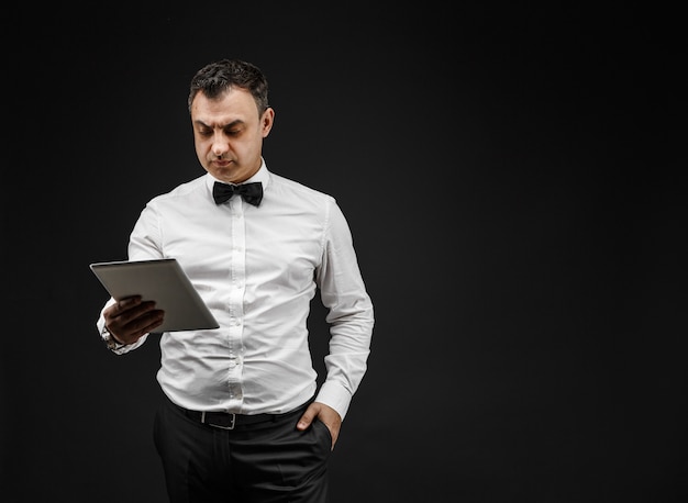 Elegant man looking at pad