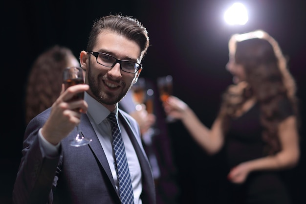 Elegant man raising his glass with the toast holidays and events