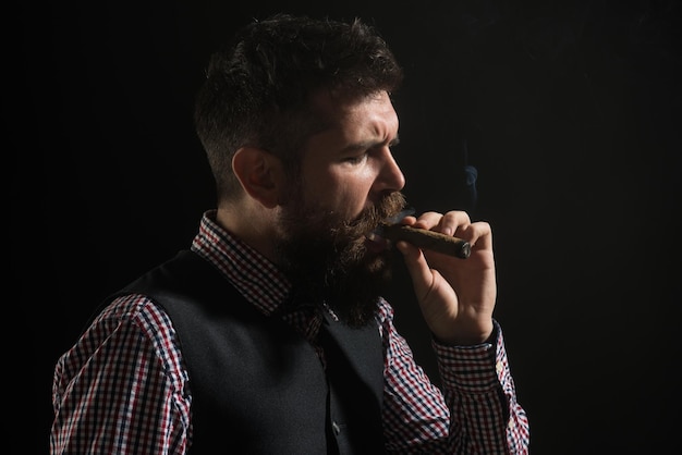 Elegant man with beard smoking cigar macho man with cigar\
classical vintage male portrait gentleman