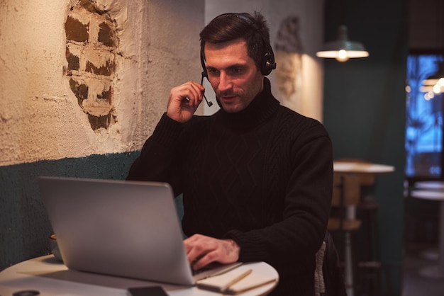 Elegant man with gadgets during onine conference in bar