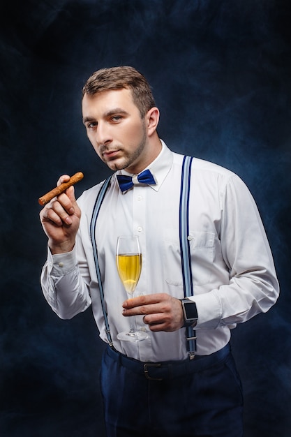 Elegant man with glass of champagne and cigar