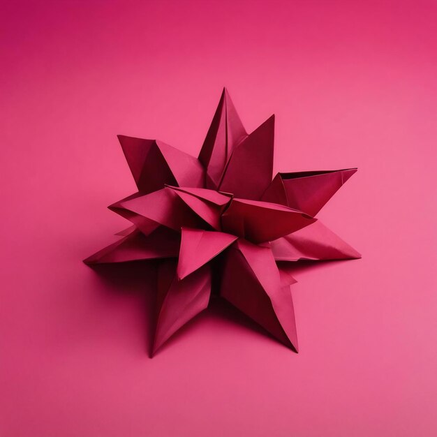 Elegant maroon red origami paper on pink background