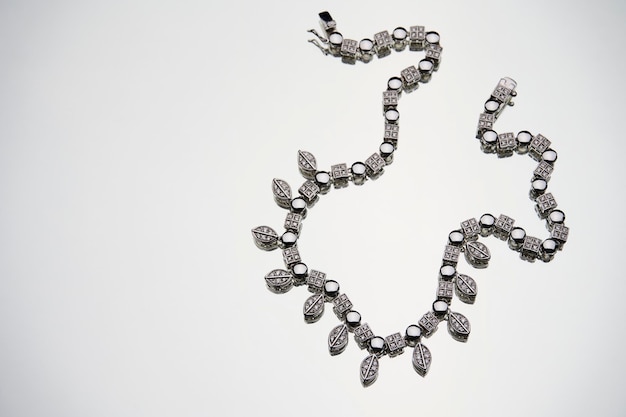 Elegant necklace with diamonds on white background