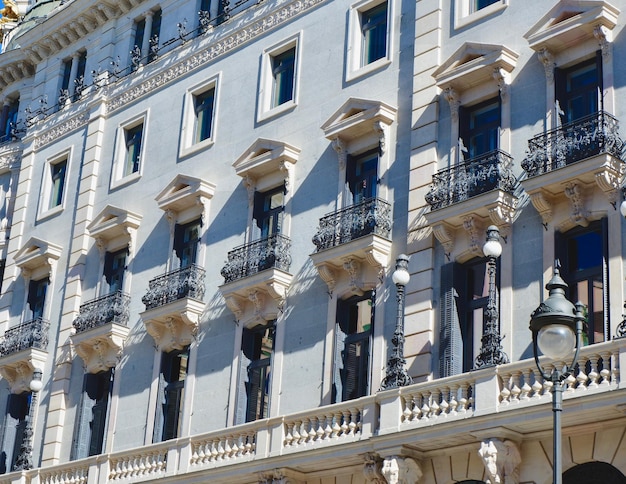 Elegant noble facade of the building lit by sun in the central district of Madrid Spain