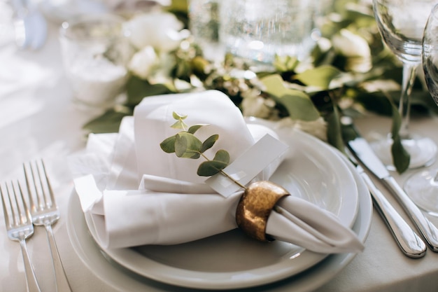 Elegant Place Setting with gold and white decoration in restaurant Table set