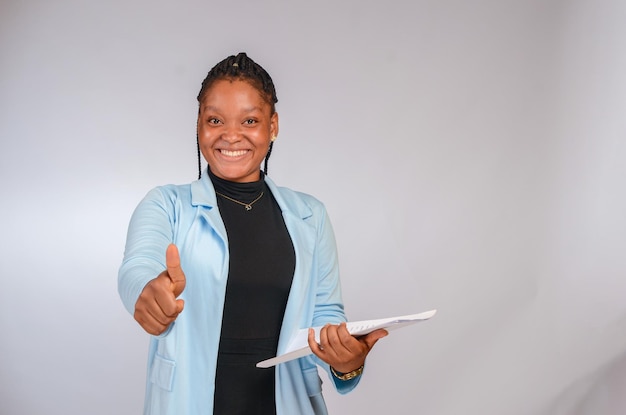 Elegant pretty businesswoman isolated in a white background holding file