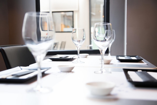 Elegant restaurant table with cutlery, crockery and glasses.