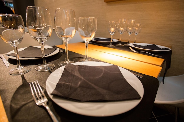 Elegant restaurant table with cutlery, crockery and glasses.