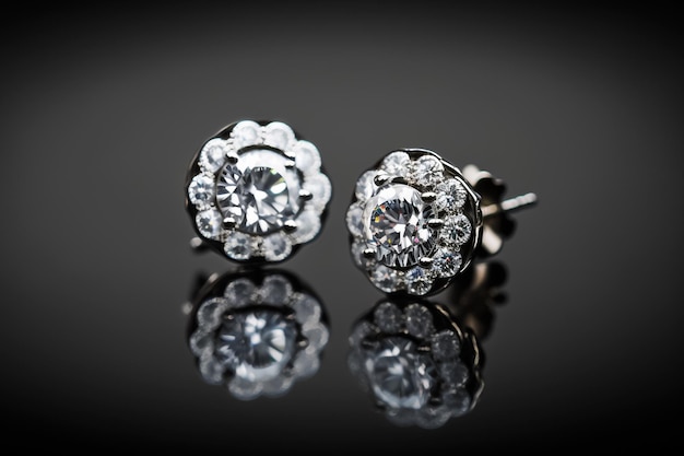 Elegant shiny Sparky platinum and diamond earrings with black background.