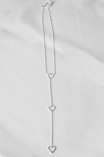 Elegant silver necklace jewelry with heart shaped details White background