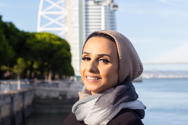 Elegant smiling arabic woman. portrait of woman with covered\
head and make up looking at camera with bright smile.\
international, beautiful concept